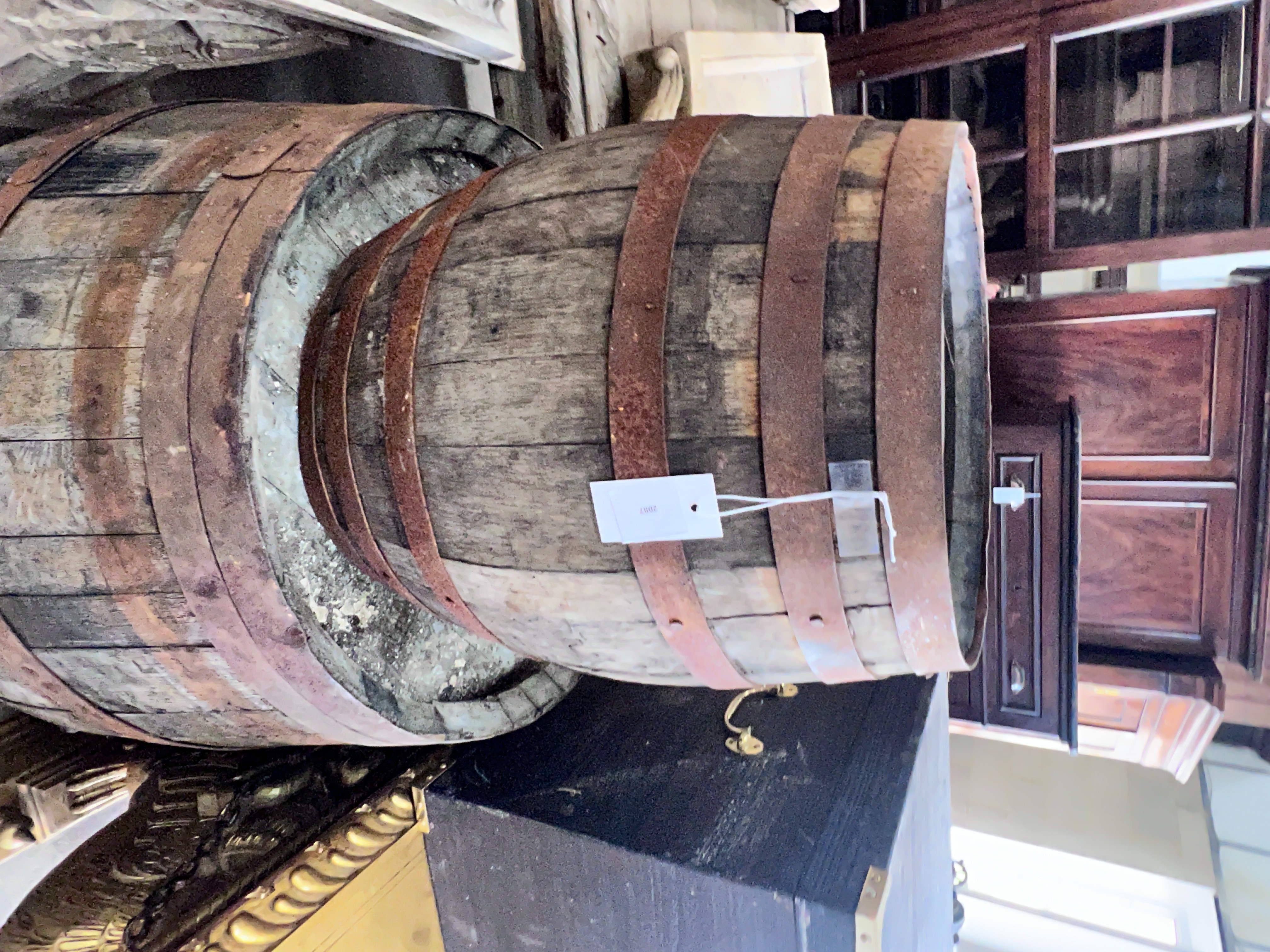 Three iron bound staved wood barrels, largest height 98cm